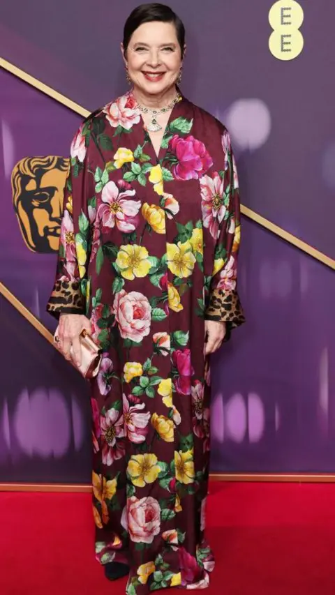 Getty Images Isabella Rossellini in a purple, pink and yellow floral long, floaty dress