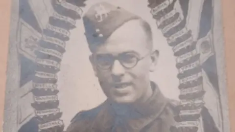 Wellstead family A young man in army uniform with round glasses in a faded official army photo.