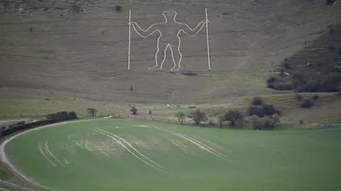 Getty Images An image of the Long Man of Wilmington in Wilmington, East Sussex. The chalk man figure can be seen on the hill, carved out in white.