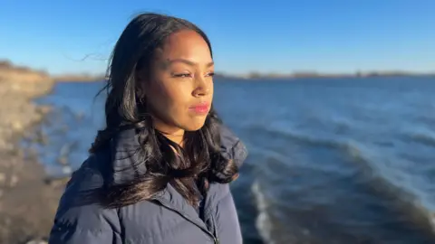 Rianna Croxford, BBC reporter, overlooking the sea in the Hamptons