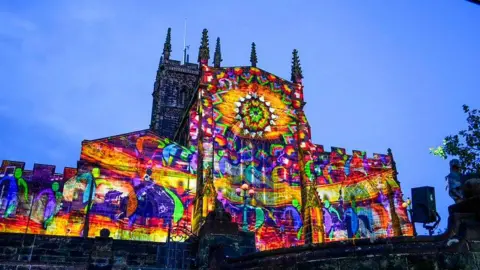 A Wolverhampton church illuminated with a multi-coloured light show.