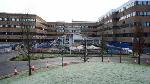 Queen's Medical Centre's entrance is pictured. It is a large multi-storey facility made of a number of joined up buildings
