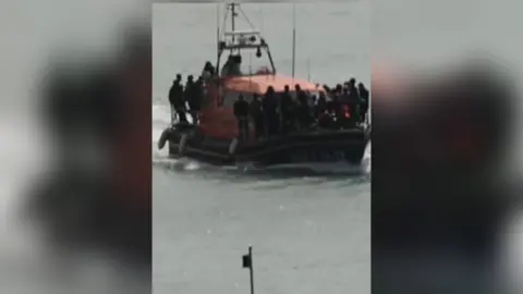 Crowded boat travelling across the water.