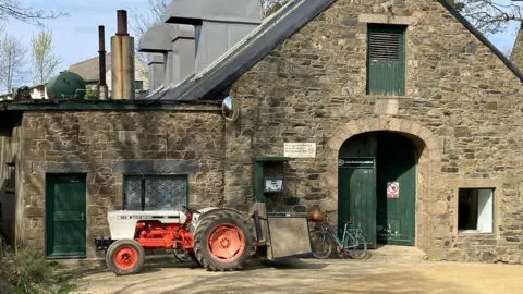 BBC A stone building with green doors - which houses the electricity generator in Sark.