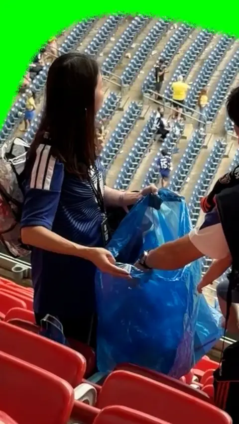 Japan fans cleaning up after the game