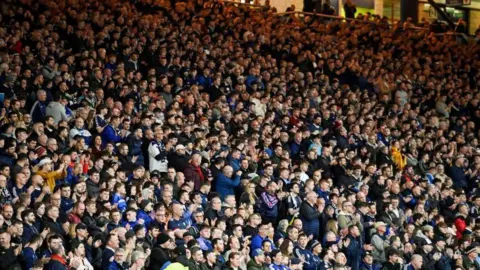 SNS Crows of football fans clapping their hands during a tribute