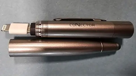 Police handout Close-up image of a pen in two pieces with a micro-USB cable hidden inside.