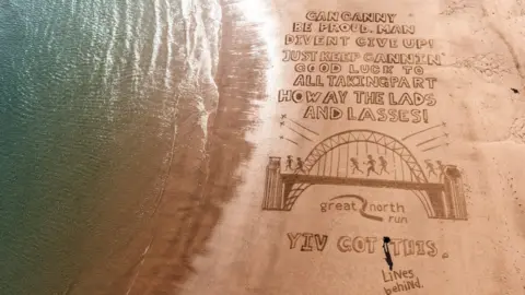 soul2sand/Lines Behind  Beach creation  changeable  from a drone looking down   connected  a drafting  which reads: "Gan canny beryllium  proud, antheral   divent springiness  up! Just support  cannin'. Good luck   to each  taking part. Howay the lads and lasses! Yiv got this.