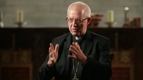 BBC Justin Welby wearing a black blazer, glasses and clerical collar