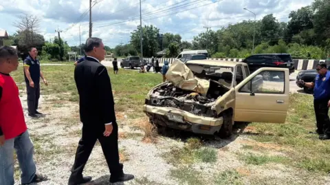Authorities investigating the truck that is smashed at the front on the side of the road