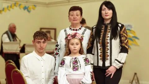 Family portrait featuring Liudmyla Zhyhunova, her mother Olha Pidhorodetska and her two children Vladyslav and Yeva.