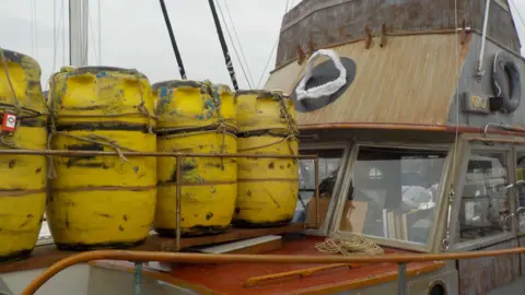 Jon Fieldhouse Yellow flotation barrels on a replica boat from the film Jaws 