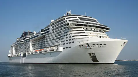 MSC Virtuosa, a large cruise ship with at least 10 visible decks, is pictured at sea
