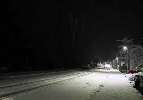 Ingrid/BBC Weather Watchers A photo of a snowy street in Lochcarron in Scotland