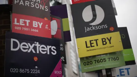 Yui Mok/PA Wire A mixture of letting display signs from estate agents.