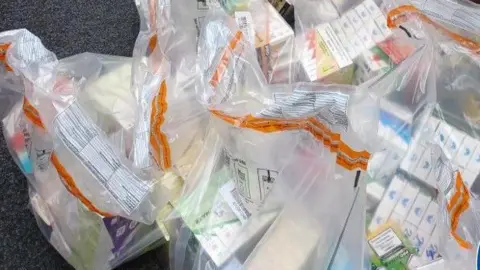 West Midlands Police Multiple sealed clear bags of counterfeit goods.