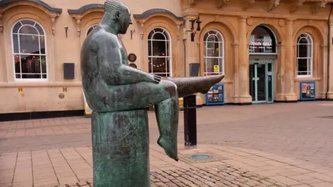 Charnwood Borough Council The bronze Sock man statue outside Loughborough Town Hall