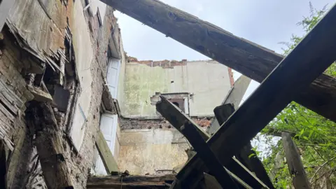 Photograph of the partially collapsed inside of Winstanley Hall in Wigan. 