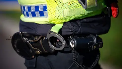 A stock image of a police officer's handcuffs.