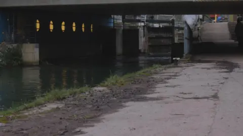 Dom Thompson A footpath is shown running alongside the canal towards the underpass and a lock system. The new lighting can be seen under the bridge.