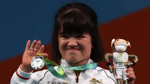 Olivia Broome holds up her silver medal during the 2022 Commonwealth Games
