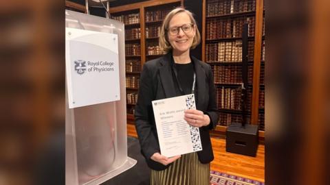 Kathie McPeake, the Macmillan Living with Cancer programme manager pictured with the award from the Royal College of Physicians