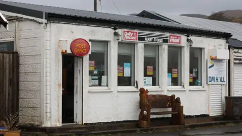 Peter Jolly/Northpix The shop is a simple white-walled, single storey building with a row of five windows and advertising boards.