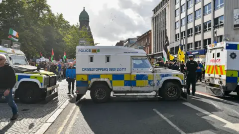 Pacemaker A PSNI Land Rover parked in front of anti-racism demonstrators outside City Hall in Belfast 