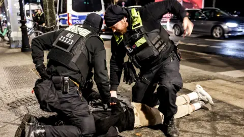 Berlin police arrest a suspect near the scene. 