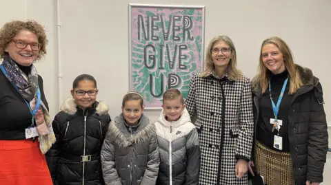 Bedfordshire Hospitals NHS Foundation Trust Students from Icknield School with staff from the hospital with a work of art