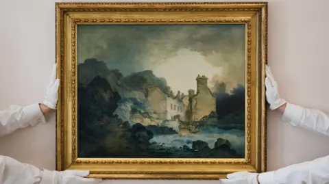 Two pairs of hands holding up a framed oil painting by Turner. The painting shows a Georgian house amongst tree-lined cliffs. It is made of quite dark colours and has a moody sky.