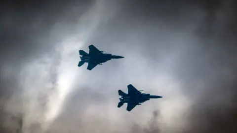 Two RAF jets in a cloudy sky.