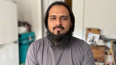 Mohammed Shoeb Iproliya looking at the camera