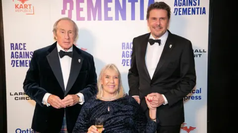 Sir Jackie, Lady Stewart and Mark all dressed up for a black tie event.
