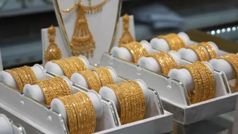 24-carat gold bangles on display at a jewellery shop in Bradford.