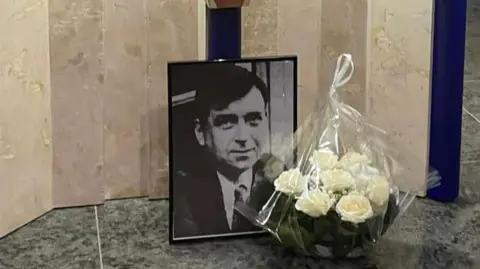 Liverpool Archdiocese Photo of John Traynor in front of a church altar