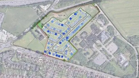 This is an aerial map showing a proposed housing development. The map outlines the development area with proposed houses depicted in blue, adjacent to existing residential areas and a hospital. 
