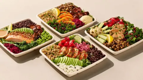 Pret/LinkedIn Four salads in bowls positioned into a diamond pattern, one with salmon, two with chicken and one with butternut squash.