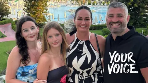 Tim Harris Tim Harris stands smiling with his wife Natalie and two teenage daughters on holiday, with a huge swimming pool in the background. The girls are wearing floral strapless tops, his wife a black and white print halter dress, and Tim is wearing a black polo short.