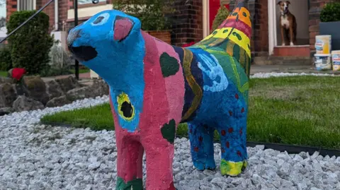 James Bowman A view of the multicoloured painted Superlambanana sculpture from the front