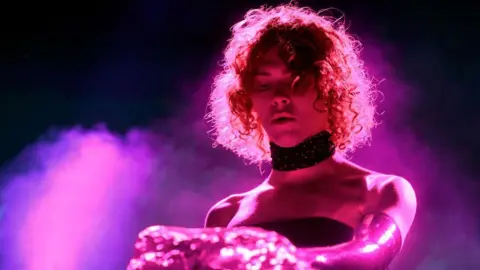 Getty images Sophie performs at the 2019 Coachella Music Festival wearing a black choker and pink gloves