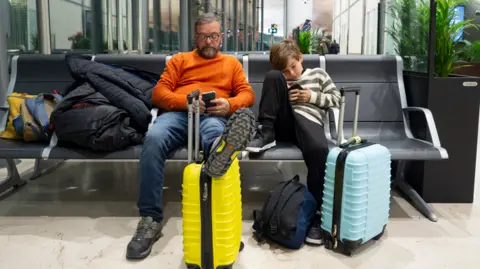 Getty Images Father and son at airport