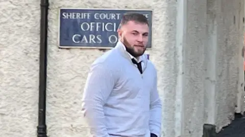 Lewis Hall walking towards Jedburgh Sheriff Court with his hands in his pockets