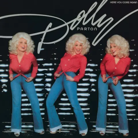Donaldson Collection/Getty Images Album cover for "The Fairest of Them All" by Dolly Parton which was released in 1977. Three version of Dolly appear on the cover, all in a red top and jeans. 