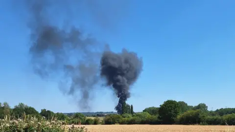 Councillor Amy Wheelton Smoke rising over farmland