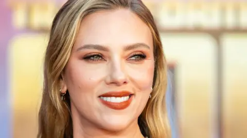 Getty Images Scarlett Johansson smiling at a premiere