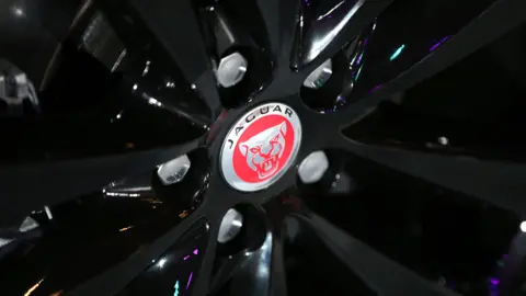 A close-up photo of a wheel of a Jaguar vehicle