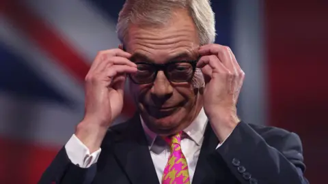 Reuters Nigel Farage wearing glasses astatine  the Reform enactment      conference