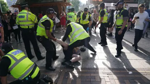 PA Media Officers reacting at the scene of the protest in Nottingham's Old Market Square