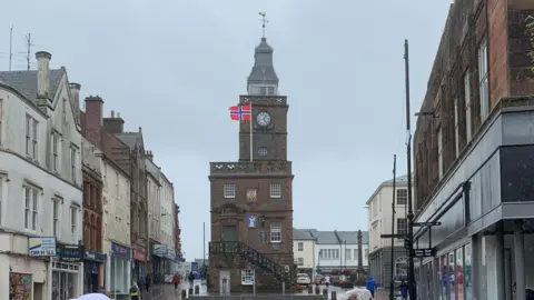 The Norwegian flag flying above the historic Midsteeple building in the heart of Dumfries
